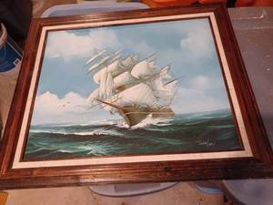 lot 13 image: Sofa Picture of a Sea Side Village 38-inches wide X 26-inches tall and a Sailing Ship Picture 24-inches wide X 20.5-inches