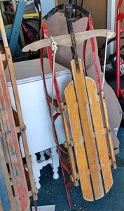 lot 16 image: Two Vintage Steerable Sleds with Metal Runners and Wood Seats (1 is 13-inches wide X 60-inches long)