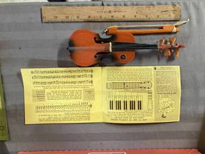 lot 34 image: Wooden Minature Toy Violin and a Carnival Instruments Brochure