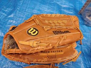 lot 74 image: Five Leather Baseball Gloves, Pair of Rawlings Gloves, Roller Blade Wrist Guard, and an Upper Deck Ichire Bobblehead