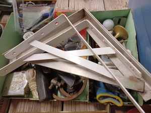 lot 130 image: Two Metal Work Bench Trays full of Assorted Tools and Hardware Items including Shelf Brackets, Hole Saws, Tape Measure