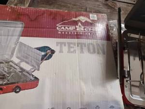 lot 137 image: Teton Camp Chef Propane Camping Stove with Original Box, was Folded up While Stove was lit and spintered some of the