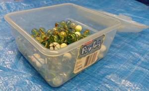 lot 149 image: Flip Top Clear Plastic Container Partially Full of Assorted Marbles