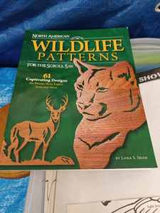 lot 153 image: Clear Tote of Wood Project Patterns, a Paperback Book of Wildlife Patterns, and New Finished Wood Plaques