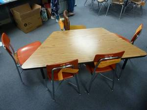 lot 105 image: Room 147 Trapezoid Table & Orange Chairs