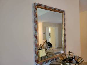 Mirror with carved and twisted design.