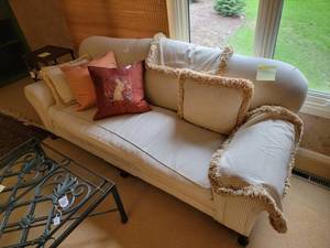 Vintage sofa and pillows in good condition.