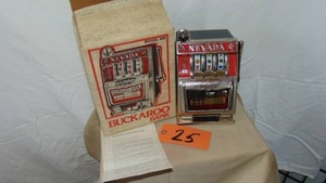 lot 25 image: Buckaroo Model 600 Metal Slot Machine Bank with Box and Instructions