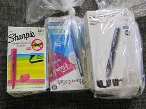 lot of pens and sharpies all open b...