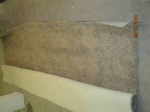 Large roll of carpet in brown tones.