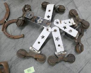 lot 86 image: Milk crate full of neat door rollers and other rusty treasures