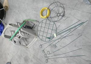 lot 94 image: Plant stakes, flower basket, sprinkler and garden hose reel