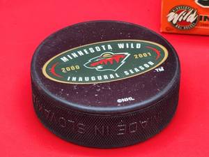 lot 97 image: Miniature Minnesota Wild Wheaties Box with (2) Official NHL Minnesota Wilds Inaugural Hockey Pucks