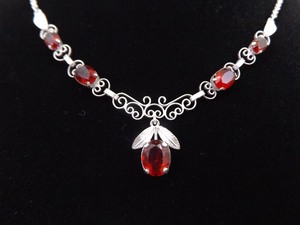 lot 16 image: .925 Sterling Silver Oval Cut Garnet Crystal Scrolled Leaf&nbspDangle&nbspPendant Necklace