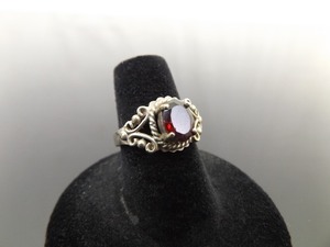 lot 48 image: .925 Sterling Silver Oval Cut Garnet Scrolled Ring Size 6.25