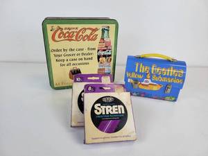lot 253 image: Coca-Cola Puzzle in Tin, The Beatles Yellow Submarine Tin, and Fishing Line