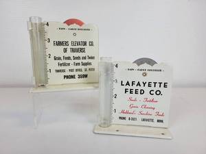 lot 414 image: Pair of Vintage Rain Gauges - Lafayette Feed Co. and Farmers Elevator Co. of Traverse