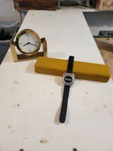 lot 450 image: Tiffany & Co. Solid Brass Desk Clock, Serial No. 215389 and Early Digital Watch