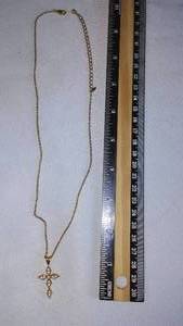 lot 47 image: Gold Colored Cross and necklace.