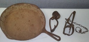 lot 145 image: Cast Skillet, rope tie and varmint trap.