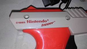 lot 216 image: Nintendo Gun Zapper plus 3 controller and more.