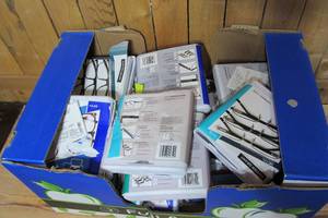 Box of opened reading glasses - different styles and different powers