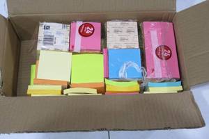 Box of mixed colored post it notes