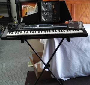 lot 60 image: Yamaha PSRE243 Keyboard with stand.