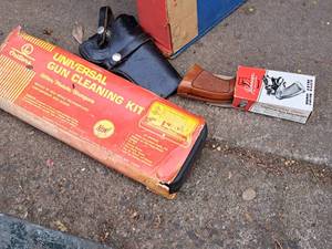 lot 404 image: Lot of (3) Gun Accessories - Universal Gun Cleanng Kit, Pachmayr Piston Grips, Black Leather Pistol Holster