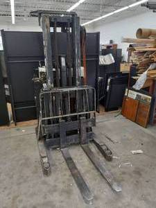 lot 89 image: BAKER STAND UP FORKLIFT AND BATTERY CHARGER