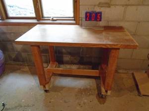 lot 205 image: Wooden shop table on casters. Approx 4 x 2. As shown.