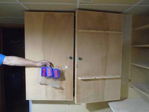 lot 298 image: Approx 4 x 4 wood tool storage cabinet. Mounted to wall so bring tools. As shown.