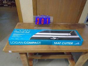 lot 301 image: logan compact mat cutter. Very little use. As shown.