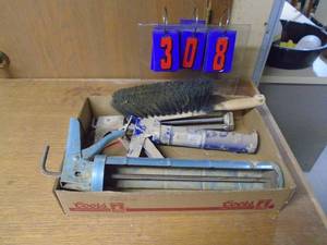 lot 308 image: Flat with caulking gun including quart. As shown.