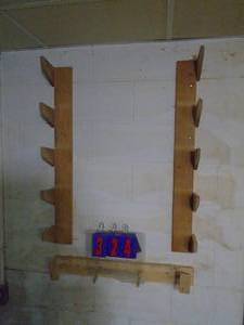 lot 324 image: Wall clamp rack. You will need to remove. As shown.