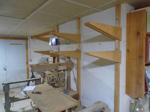 lot 325 image: Wall mount lumber rack. You will need to remove. As shown.