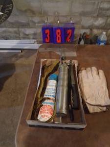 lot 382 image: grease gun, gloves & etc. As shown.