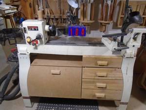 lot 104 image: Jet wood lathe. 14 x 42 with face plates chucks & lots of accessories. Tools in background sold seperatly. As shown.
