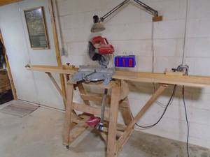 lot 110 image: Milwaukee miter saw with stand. 8 long table. Very nice shape. As shown.
