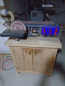 lot 112 image: Craftsman 6 belt sander with disc & cabinet. Extra belts in cabinet. As shown.