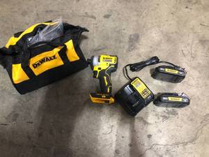 lot 38 image: DEWALT ATOMIC 20V MAX Cordless Brushless Compact 14 in. Impact Driver, (2) 20V 1.3Ah Batteries, Charger, and Bag  Customer Returns See Pictures