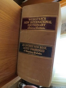 lot 98 image: Websters New International Dictionary - Second Edition With Wood Stand