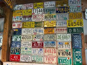 lot 77 image: Board Full of Motorcycle License Plates from Assorted States
