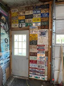 lot 223 image: Wall of License Plates - 1935 ND, 1943 MN, Canadian Plates, 1945 Ohio & Many More Good Ones