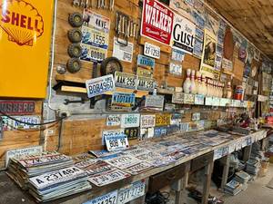 lot 229 image: License Plates on Shelf & Wall