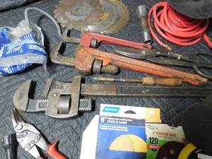 lot 67 image: 3 pipe wrenchs,saw blades,sanding discs,grinding stones,wire, and more