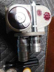 lot 69 image: vintage Bell & Howell movie camera w 2 cans of film developer and lenses