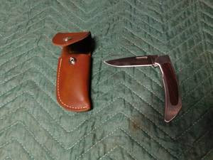 lot 87 image: Camillus knife and leather sheath