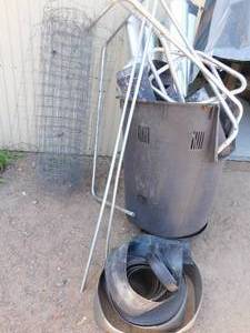 lot 109 image: Compost bin full of stove pipe, chicken wire, rubber trim
