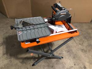 lot 5 image: RIDGID 7 In Wet Tile Saw with Stand open Box customer return see pictures